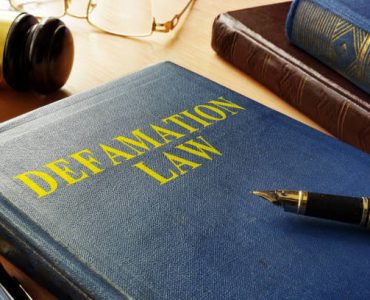Book about Defamation Law and gavel.